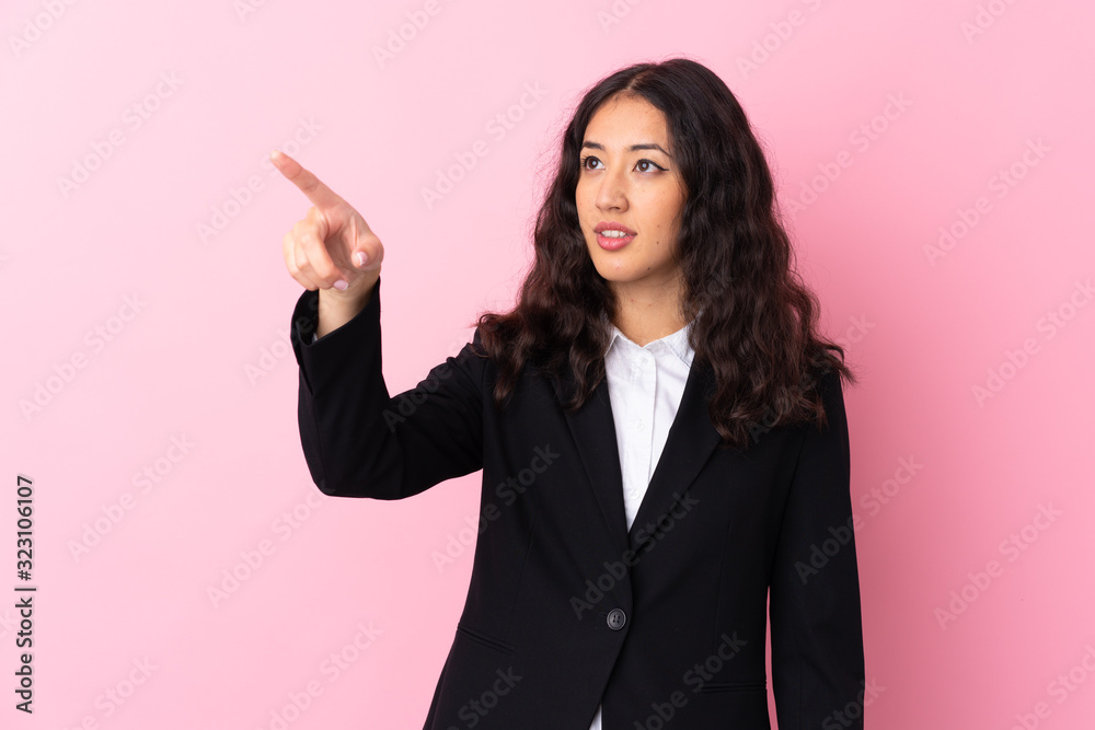 Mixed race business woman over isolated pink background touching on transparent screen Mixed race business woman over isolated pink background touching on transparent screen