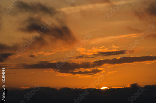 Dramatic sunset  cloudy sky of an intense orange color  in San Clemente del Tuyu