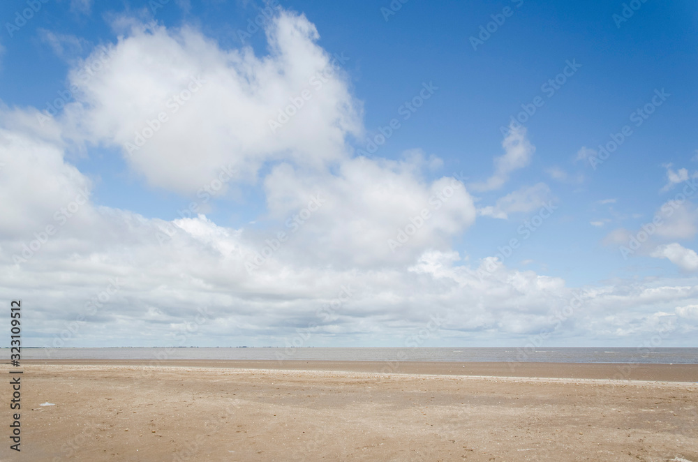 Generic beach landscape, empty; sand and a sunny sky with some clouds
