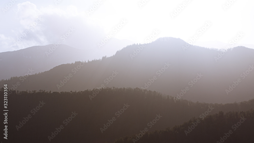 Foggy mountain peak landscape sun backlit - obrazy, fototapety, plakaty 