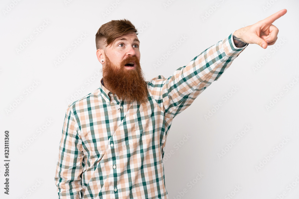 Redhead man with long beard over isolated white background pointing away Redhead man with long beard over isolated white background pointing away