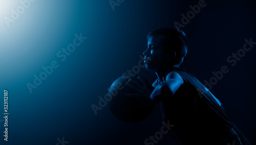 Kid playing basketball isolated on black background in mixed light. Blue filter