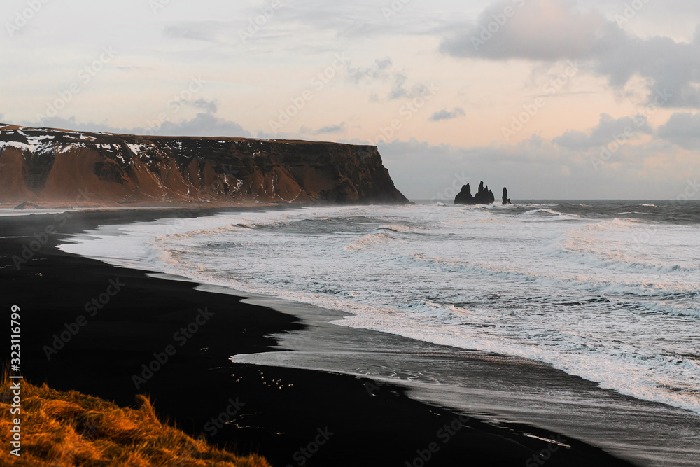 Iceland black beach Reynisfjara in Vik from Dyrholaey (Dyrhólaey) viewpoint. Coastline of black sand beach in Iceland.