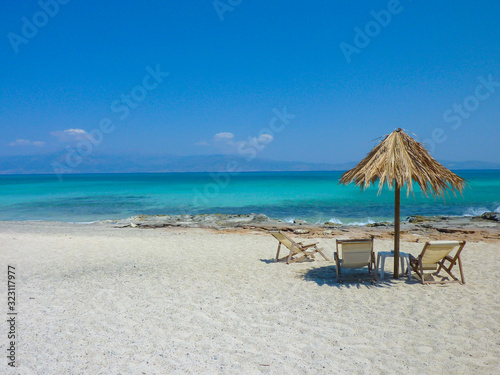 Fototapeta Naklejka Na Ścianę i Meble -  Beautiful beach landscape. Summer holiday and vacation concept. Inspirational tropical beach. Beach background banner. Dream travel scene.  Chairs and umbrella on a beautiful tropical beach