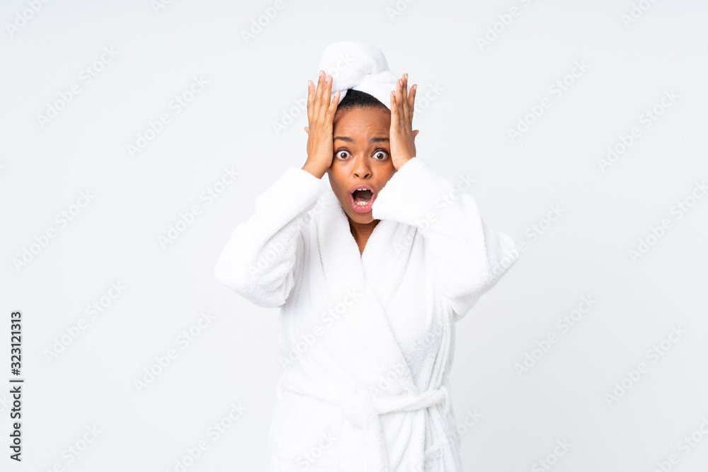 African american woman in a bathrobe over isolated background with surprise facial expression African american woman in a bathrobe over isolated background with surprise facial expression