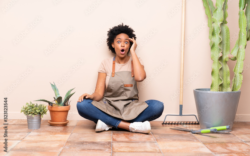 Gardener woman sitting on the floor has just realized something and has intending the solution Gardener woman sitting on the floor has just realized something and has intending the solution