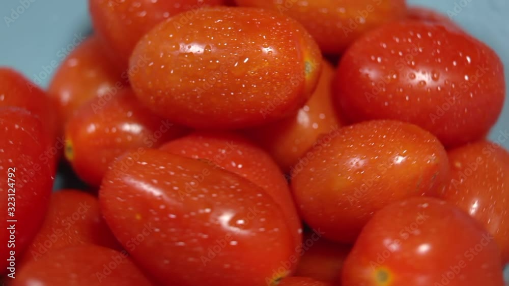 Concept of genuine and fresh tomato. Chery tomatoes on a wooden board revolve in a circle. Concept of genuine and fresh tomato. Chery tomatoes on a wooden board revolve in a circle.