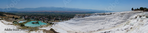 The beautiful pools of Pamukkale in Turkey. Pamukkale contains hot springs and travertines, terraces of carbonate minerals left by the flowing water. The site is a UNESCO World, panoramic view