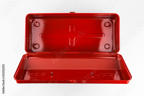 Empty classic vintage style red metal toolbox shot from above with a hinged lid in a white studio.
