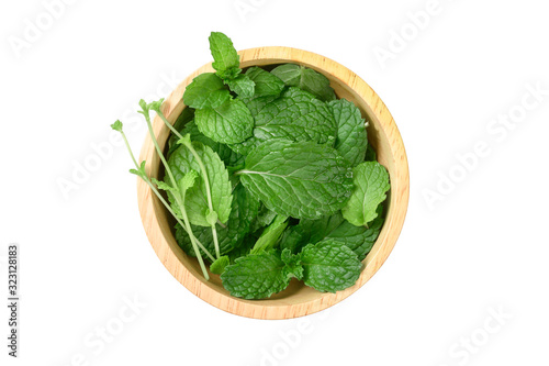 Fresh mint leaves in wood bowl isolated on white background.top view
