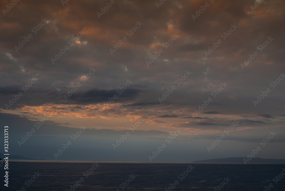 Lahaina, Maui, Hawaii, USA. - January 12 2012: Early morning light over ocean with fog near west side of the island, produces a dark cloudscape with parts as if set on fire.