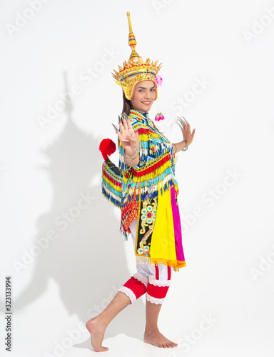 Young lady wearing Thai Tradition southern costume and put headdress on her head,showing basic pattern folk dance,black shadow reflection on white background