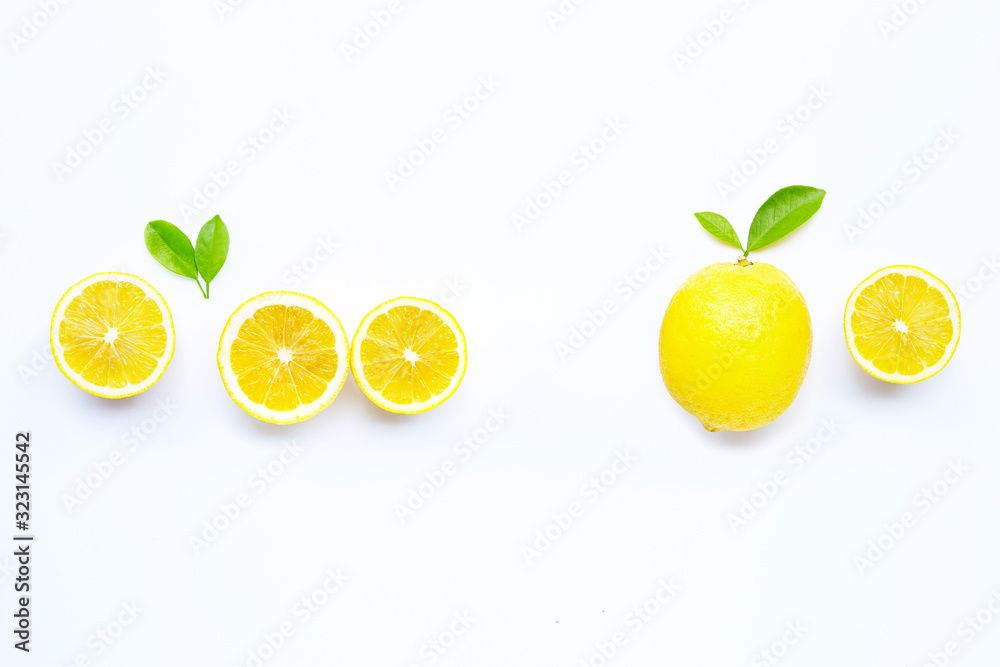Fresh lemon with green leaves on white. Copy space for text or product