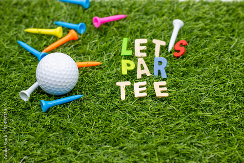 Golf Party with golf ball par tee word and tee on green grass