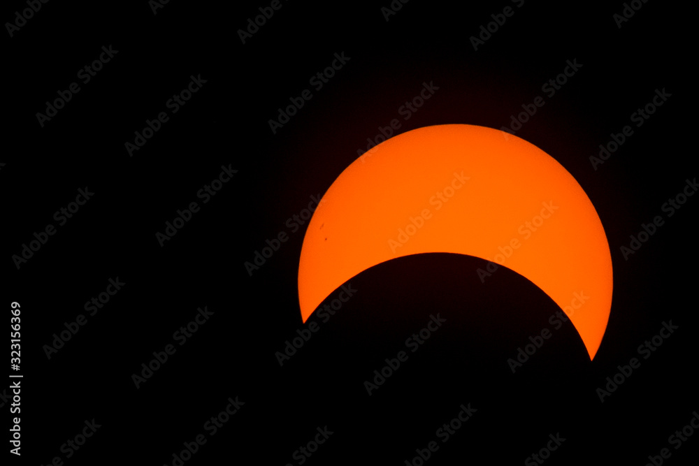 Partial solar eclipse. Sunspots are present, and turbulence can be seen on the surface of the sun, especially around the edge (this is not noise).