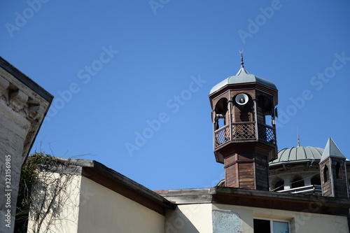 Wooden minaret of a mosque near Taksim Square in Istanbul photo