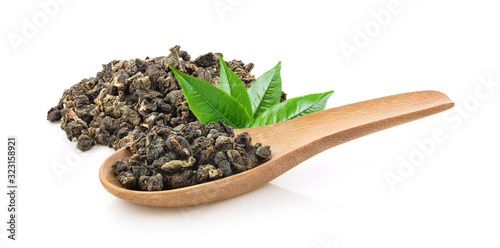 Dry tea leaves in wood spoon isolated on white