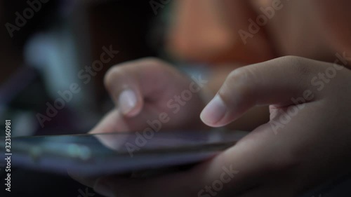 Mobile phones in hands female teenagers using looking posts on social media and chatting to friends on browsing social networks for entertainment and shopping