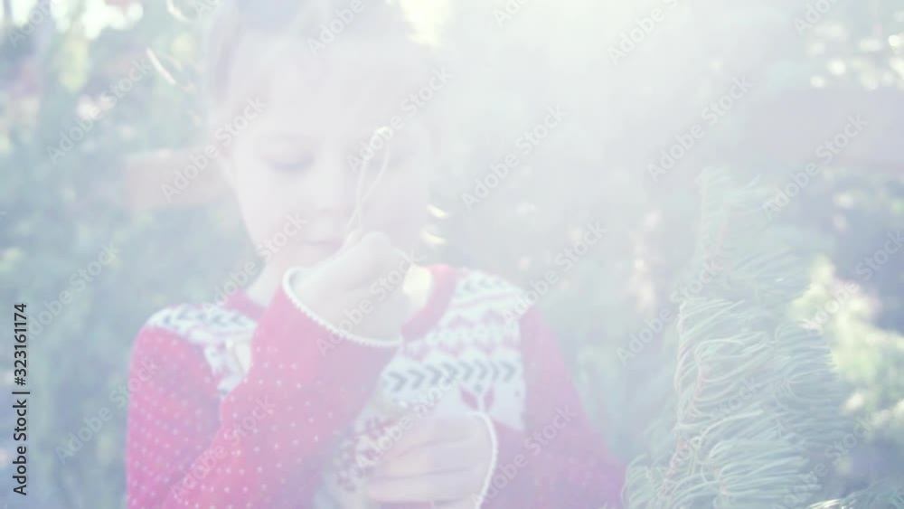 Slow motion. Little girl in red dress on Christmas tree farm.