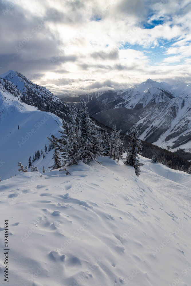 Obraz premium Kicking Horse, Golden, British Columbia, Canada. Beautiful View of Canadian Mountain Landscape during a vibrant sunny and cloudy morning sunrise in winter.