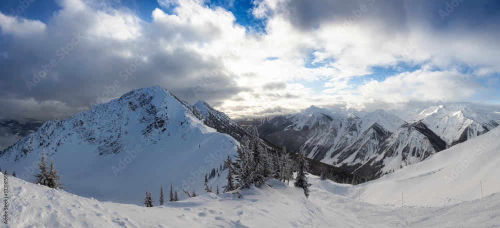 Obraz premium Kicking Horse, Golden, British Columbia, Canada. Beautiful Panoramic View of Canadian Mountain Landscape during a vibrant sunny and cloudy morning sunrise in winter.