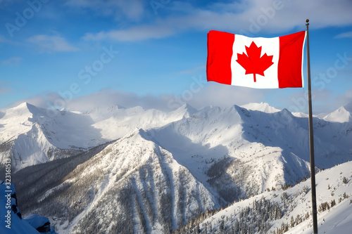 Kicking Horse, Golden, British Columbia, Canada. Beautiful Aerial View of Canadian Mountain Landscape during a vibrant sunny and cloudy morning sunrise in winter. Flag Composite