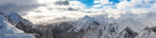 Fototapeta Naklejka Na Ścianę i Meble -  Kicking Horse, Golden, British Columbia, Canada. Beautiful Aerial Panoramic View of Canadian Mountain Landscape during a vibrant sunny and cloudy morning sunrise in winter.