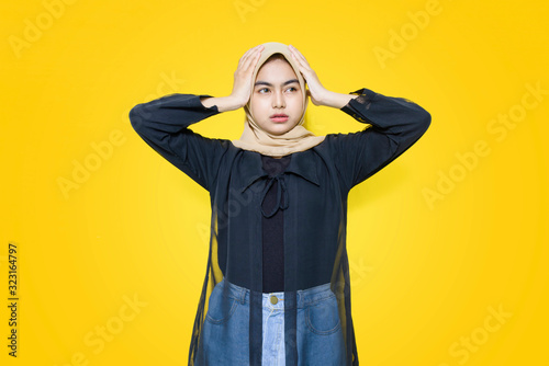 Portrait of Asian women with sad face on yellow background © Khoirul