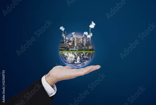 Fototapeta Naklejka Na Ścianę i Meble -  Pollution, global warming and eco-friendly business concept. Businessman holding the world with toxic industry . Element of this image are furnished by NASA