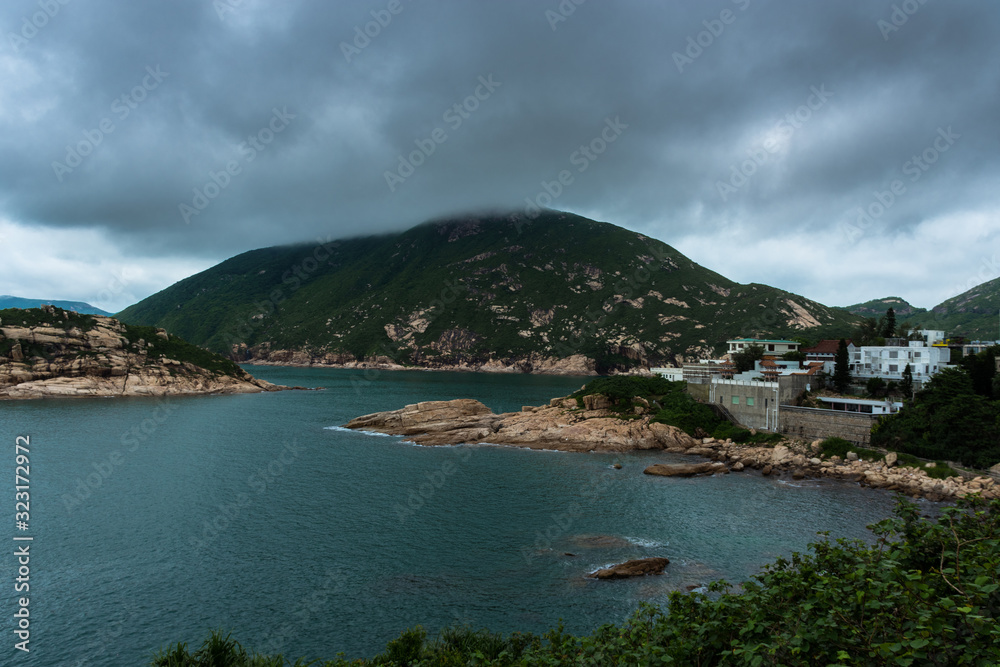 Moody Weather in Shek O, Hong Kong during dark cloudy day with island landscape