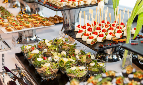 Appetizing snacks on the buffet table at the event. Close-up.