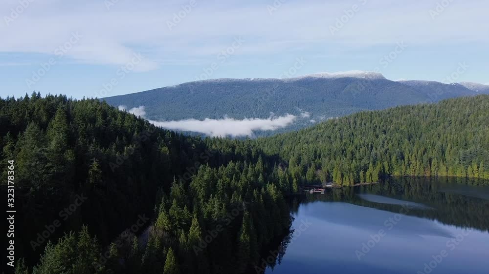 Aerial view of the mountain forest with the crystal clear lake in front Aerial view of the mountain forest with the crystal clear lake in front
