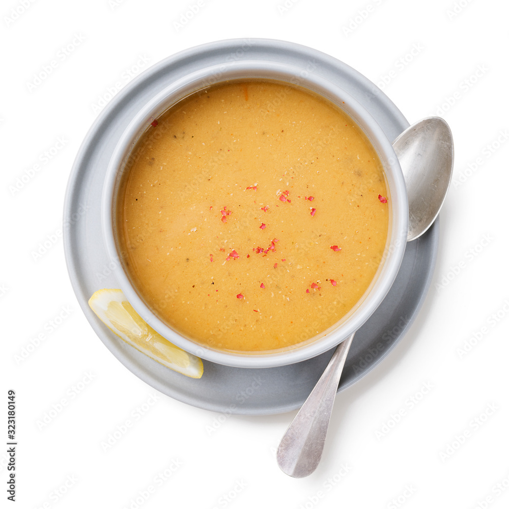 Red lentil soup served with lemon and toasted bread. isolated on white background Red lentil soup served with lemon and toasted bread. isolated on white background