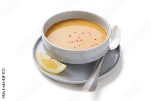 Red lentil soup served with lemon and toasted bread. isolated on white background