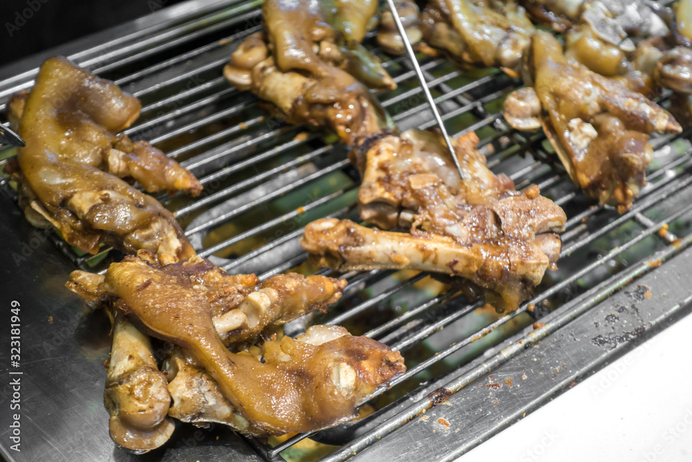 Delicious roast pig's feet on the grill