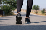 Close up Athlete running woman wearing Exercise pants and running shoe on the road,Runner woman traning in the morning.Walking for warm up her muscle.