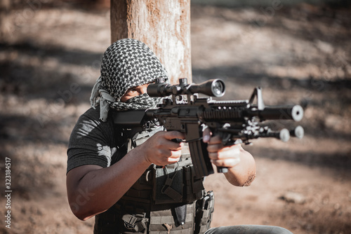 Man terrorist wearing a mask and holding a gun, Terrorist concpet photo