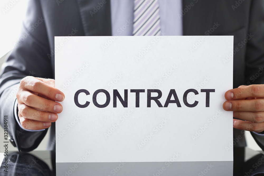 Man in suit and tie hold in arms contract closeup. Bid or tender job decision terms and conditions human resources candidate legal law client financial plan concept Man in suit and tie hold in arms contract closeup. Bid or tender job decision terms and conditions human resources candidate legal law client financial plan concept