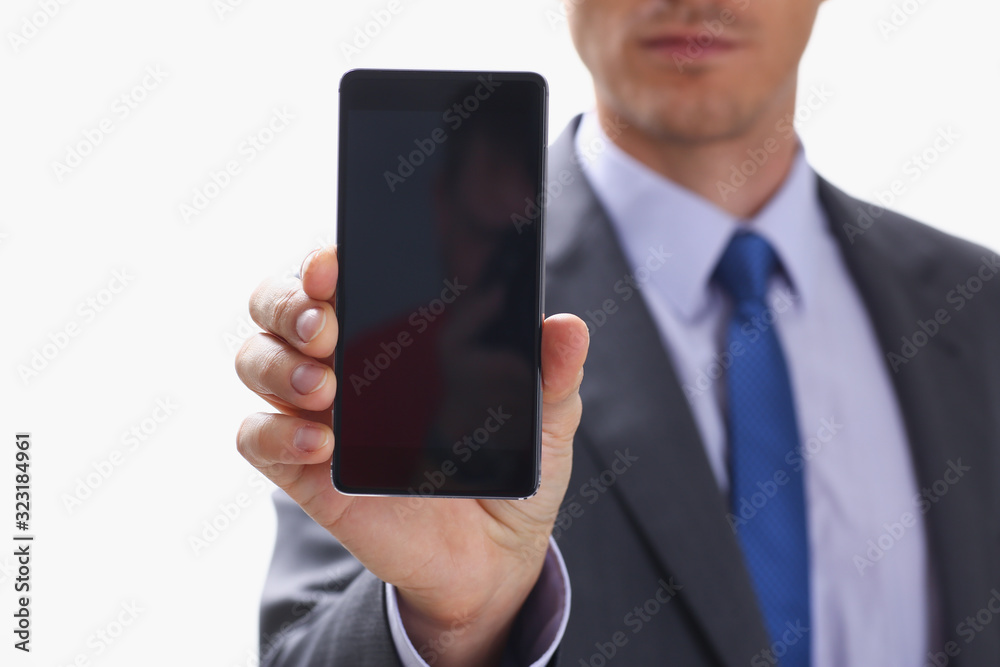 A businessman holding smartphone in hand demonstrates display on which calculator is depicted with figure of zero. The accountant has calculated all transactions are correct debt has credit approx ok A businessman holding smartphone in hand demonstrates display on which calculator is depicted with figure of zero. The accountant has calculated all transactions are correct debt has credit approx ok