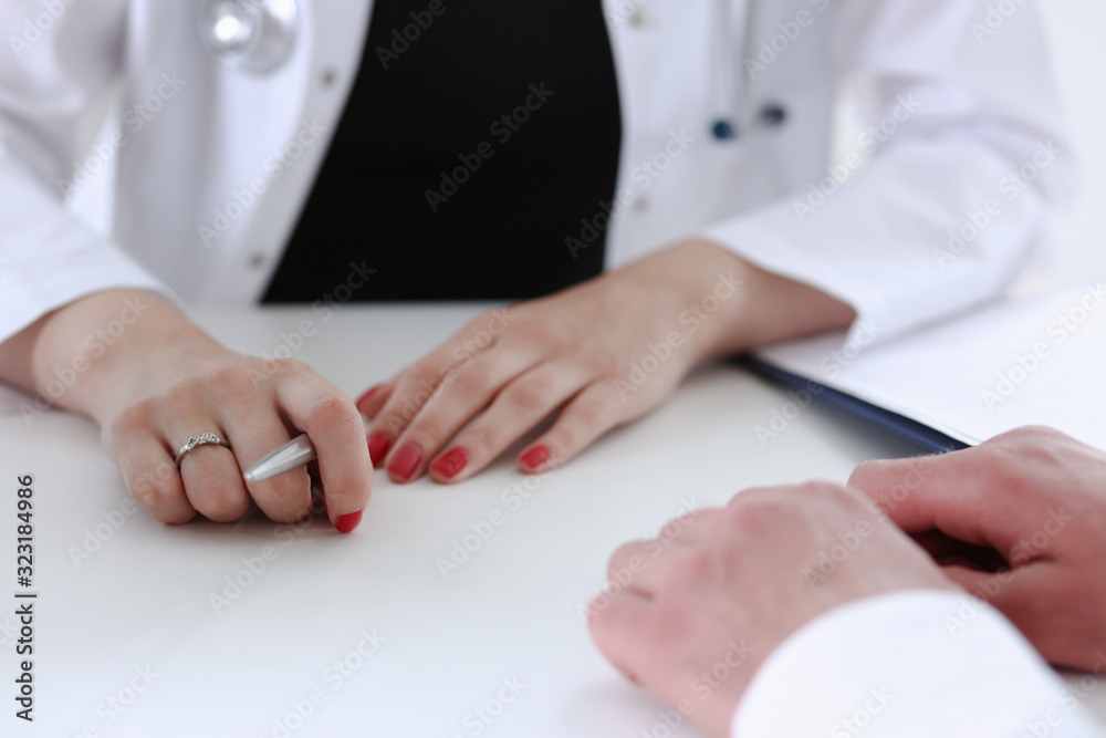 Female doctor hand hold silver pen filling patient history list at clipboard pad. Physical, exam, er, disease prevention, ward round visit check 911 prescribe remedy healthy lifestyle concept Female doctor hand hold silver pen filling patient history list at clipboard pad. Physical, exam, er, disease prevention, ward round visit check 911 prescribe remedy healthy lifestyle concept