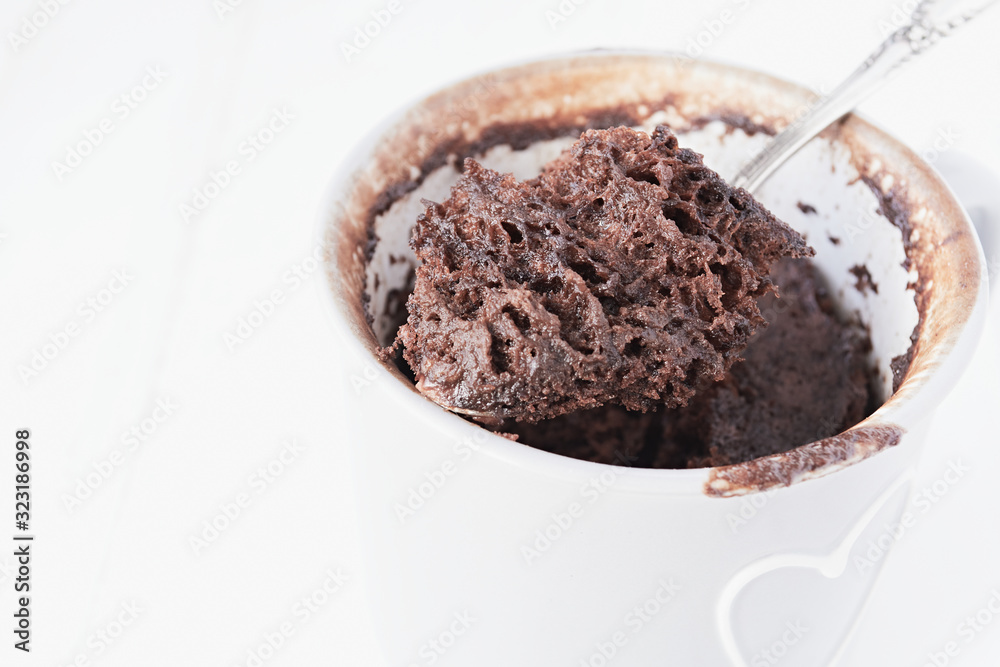 Homemade chocolate mug cake on a white background Homemade chocolate mug cake on a white background