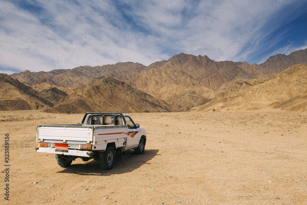 Car on the background of the Egyptian mountains in the afternoon.