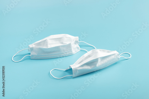 Medical mask on blue background.