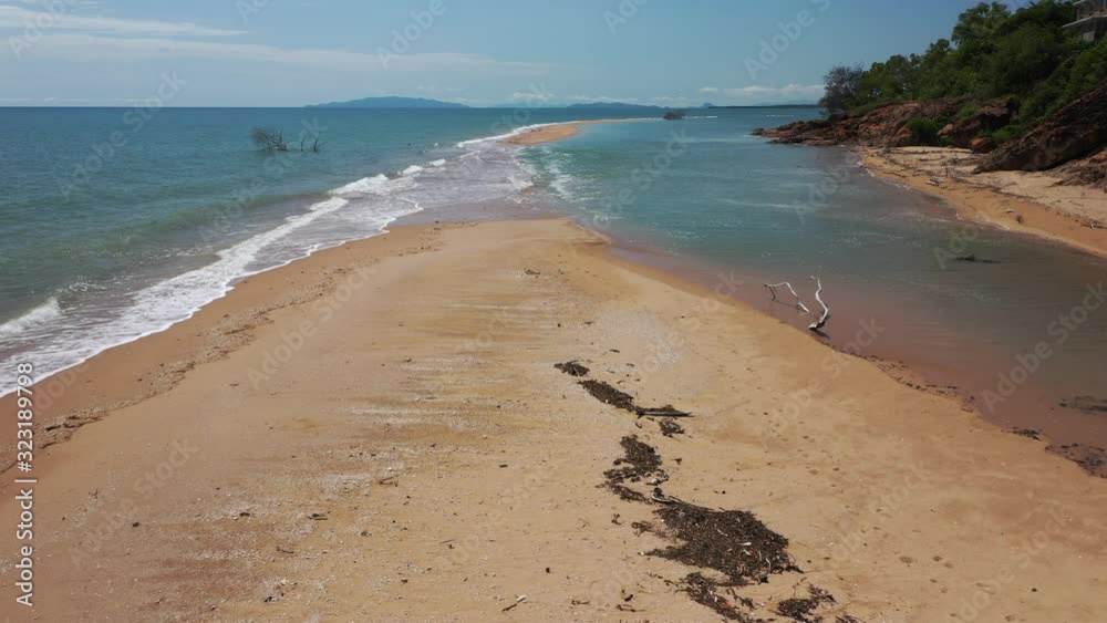 Low drone flight of sandbar on North Queensland tropical coast near Toolakea, North Queensland Australia Low drone flight of sandbar on North Queensland tropical coast near Toolakea, North Queensland Australia