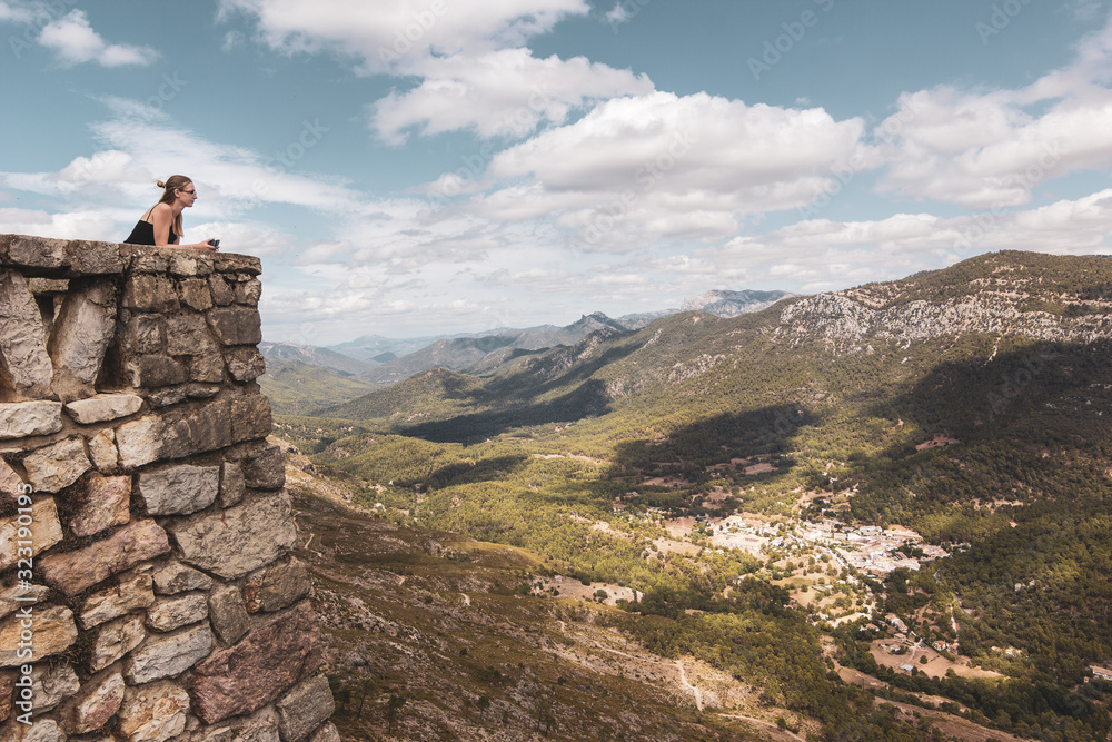 Young blonde woman admiring the landscape from the viewpoint in Puerto de las palomas