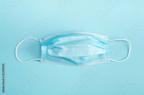 Medical mask on blue background.