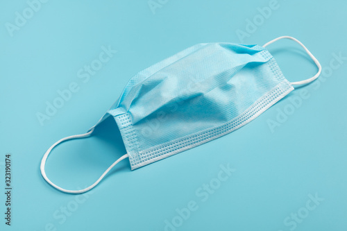 Medical mask on blue background.