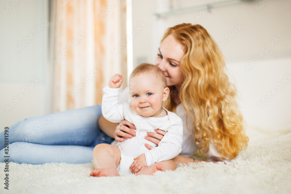 young mother tenderly hugs her little cute baby young mother tenderly hugs her little cute baby