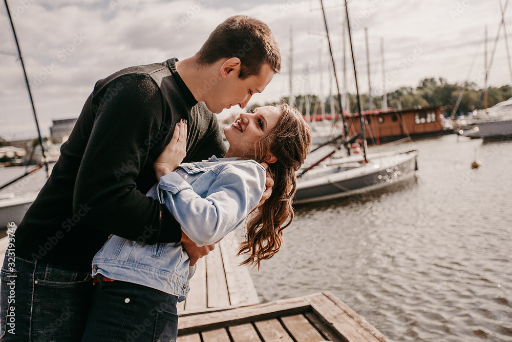Fototapeta premium Young beautiful couple walking along the waterfront / Lifestyle