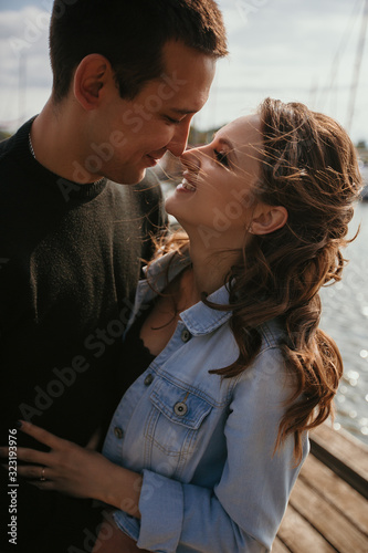 Young beautiful couple walking along the waterfront / Lifestyle